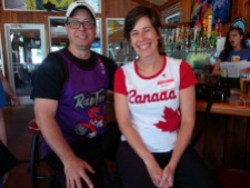 Man wearing Toronto Raptors shirt and woman wearing Canada shirt